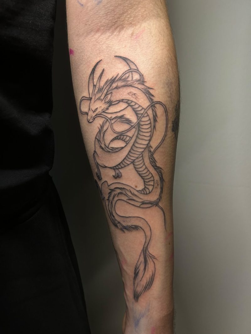 Fine line dragon winding around the forearm