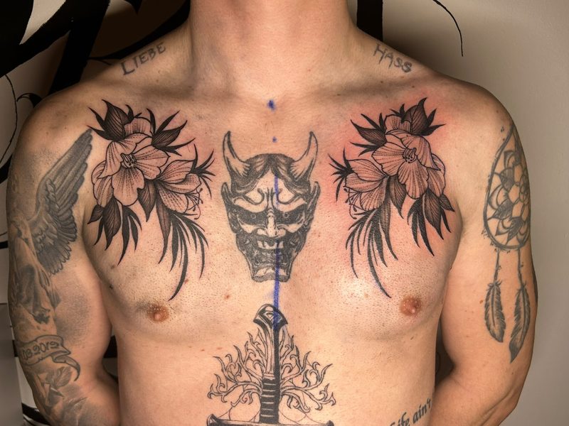Hannya mask with blossoms and dagger on the chest in black and grey