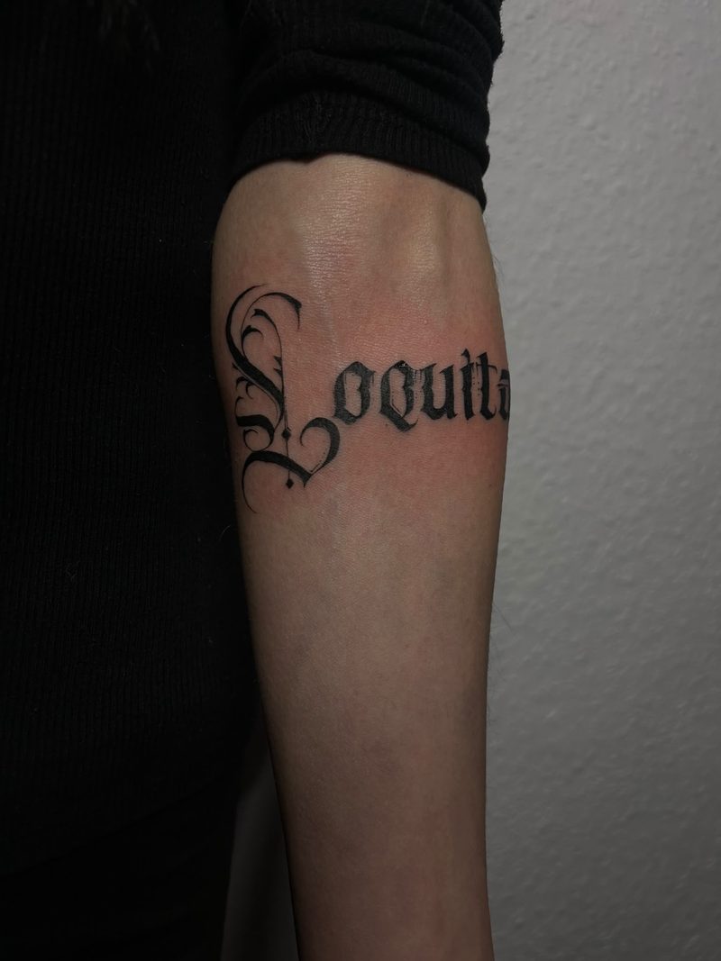 Calligraphic lettering in gothic script on the forearm