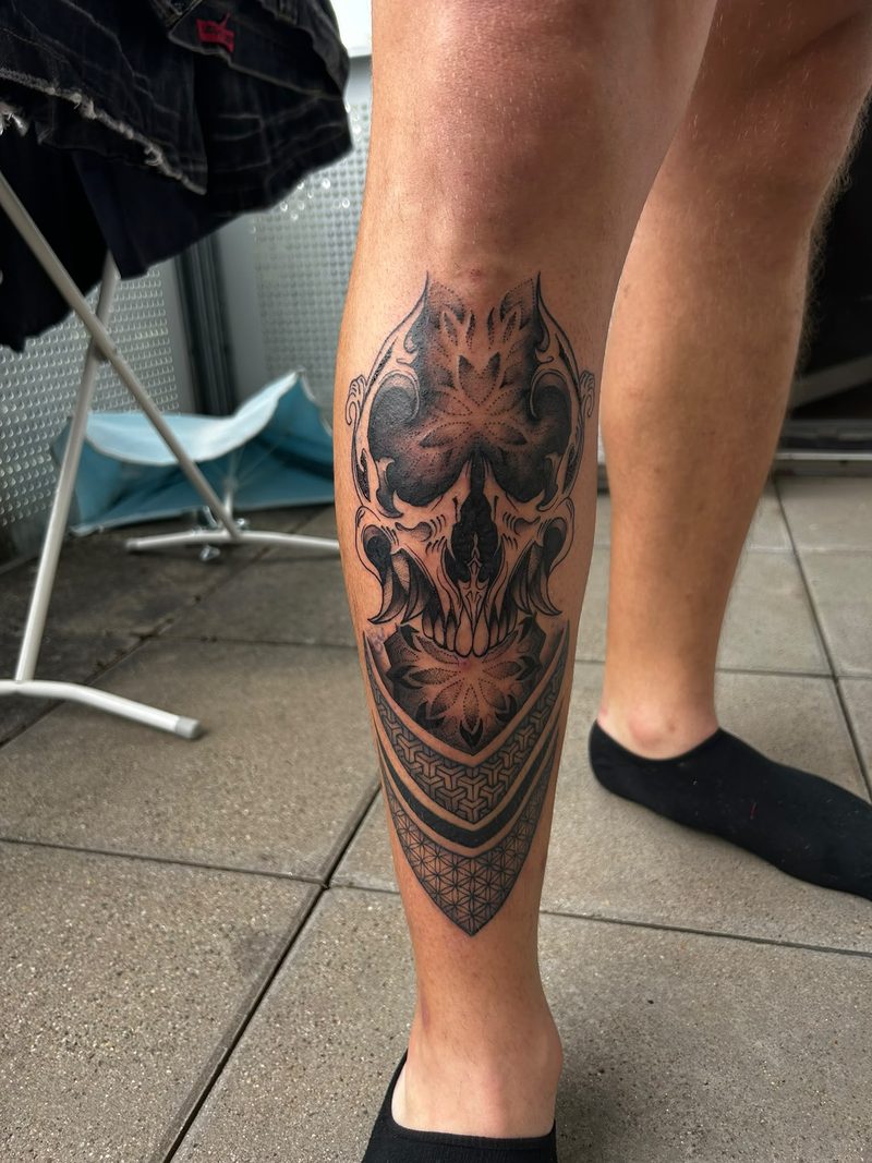 Ornamental skull with mandala and geometric patterns on the calf