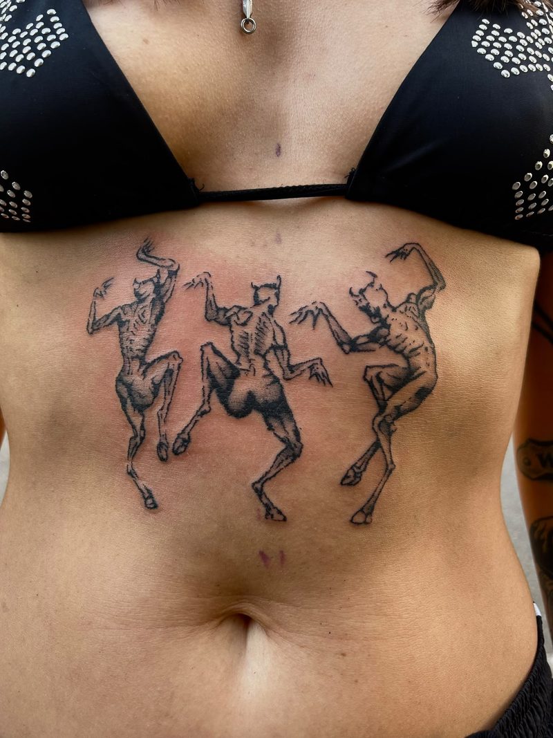 Three dancing devil figures in engraving style below the chest